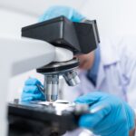 scientist using microscope